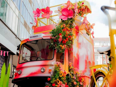 The custom Selfridges milk float, with colourful flowers.