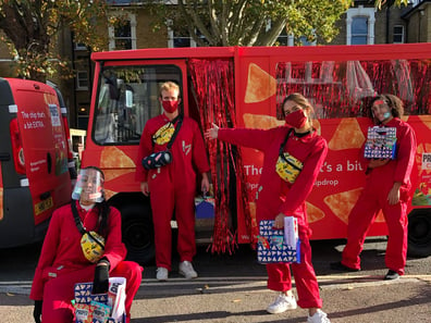 Staff in red pose alongside the milk float hired by Proper Chips.