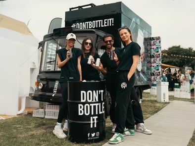 Staff pose in front of the Canowater 'Don't bottle it!' British milk float in the summer.