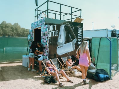 Guests enjoy a drink around the Canowater milk float, complete with a custom roof.