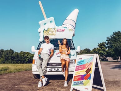 Influencers pose by the Netflix ice cream van in a park