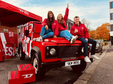 Staff sit on Diesel's Land Rover Defender hire.