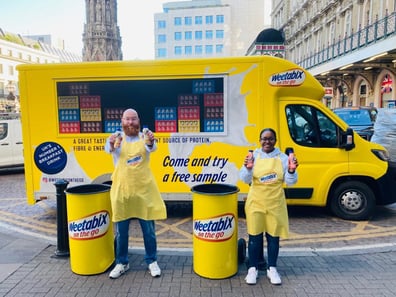 The Weetabix exhibition vehicle, with sampling bins and staff posing in front