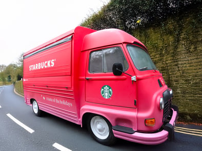 The Starbucks winter Renault Estafette hire on the road.