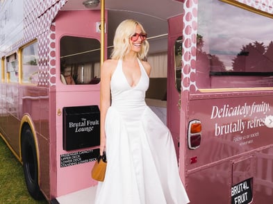 The rear of a hired Routemaster bus, with a blonde model posing.