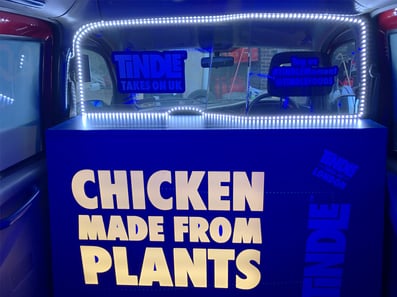 Inside the Tindle taxi, with lights and the message 'Chicken made from plants'.