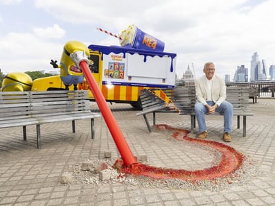 Steve Carrell sits in front of the Despicable Me US postal van hire, with a minion.