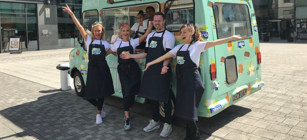 Alpro ice cream campaign staff stand in front of a custom ice cream van.