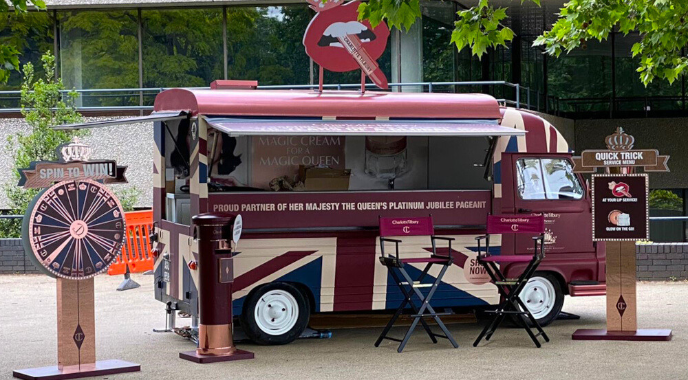 Charlotte Tilbury Estafette, with spin-the-wheel game and other 3D props.