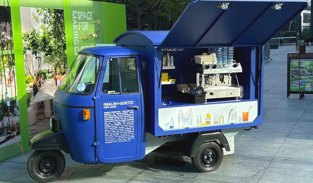 The classic Piaggio Ape available for hire, viewed from the side.