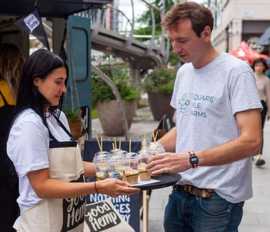 A girl handing out samples as part of a free brand experience