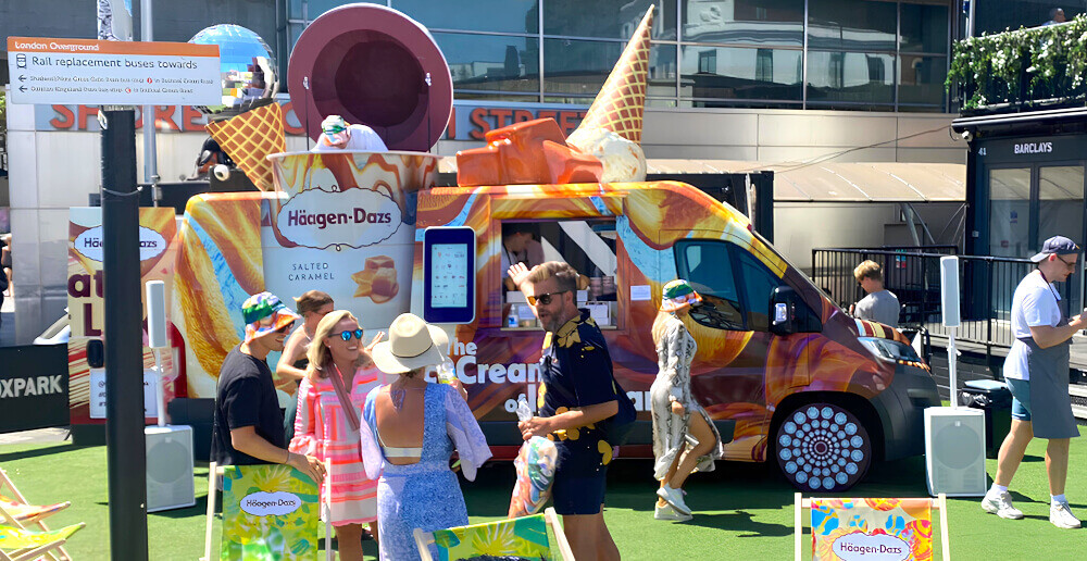 Haagen-Dazs modern sampling van at a retail park with guests around it.