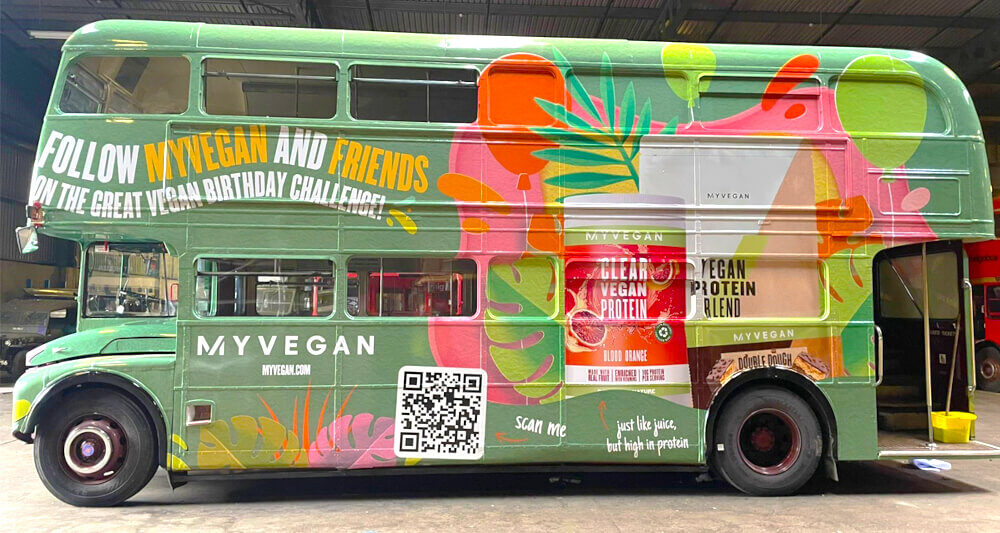 The 'My Vegan' Routemaster bus hire, wrapped in green and with a QR code.