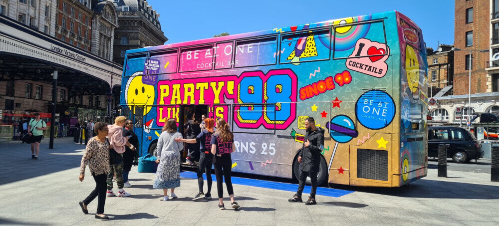 Party bus outside Victoria Station in London, thanks to Promohire's location planning services