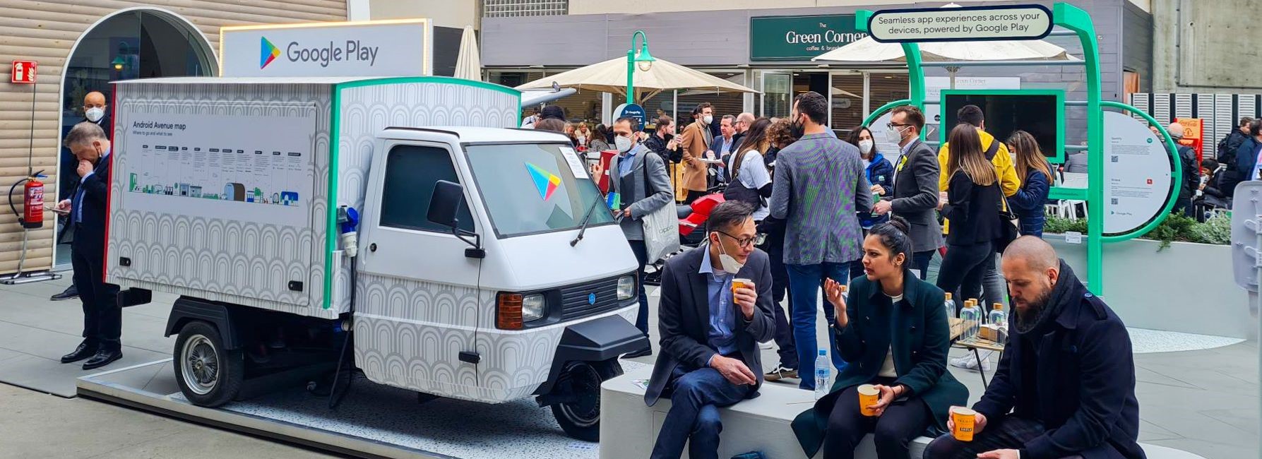 The Google Piaggio Ape hire, with a crowd in a city.