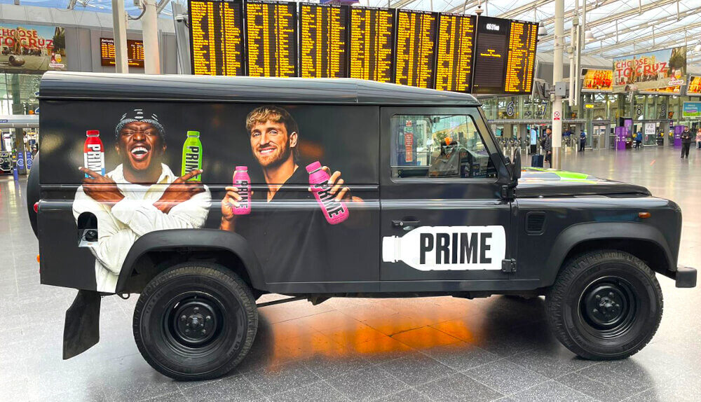 Prime Land Rover Defender, in a London train station, with imagery featuring KSI and Logan Paul.