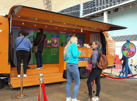 QV Skincare Airstream with the hatch open and a small crowd