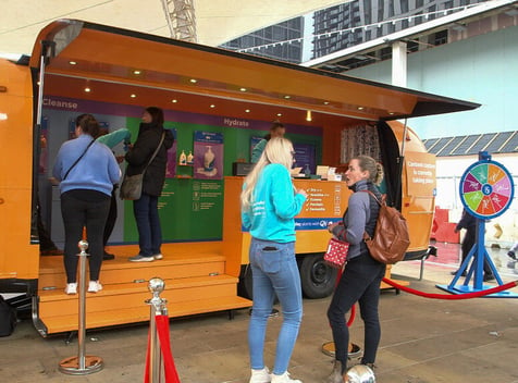 QV Skincare Airstream with the hatch open and a small crowd