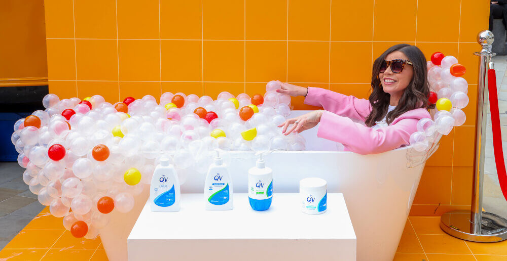 A bath prop for QV Skincare's brand activations, with a woman having fun.