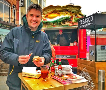 A man enjoys food from the Tabasco American truck hire.