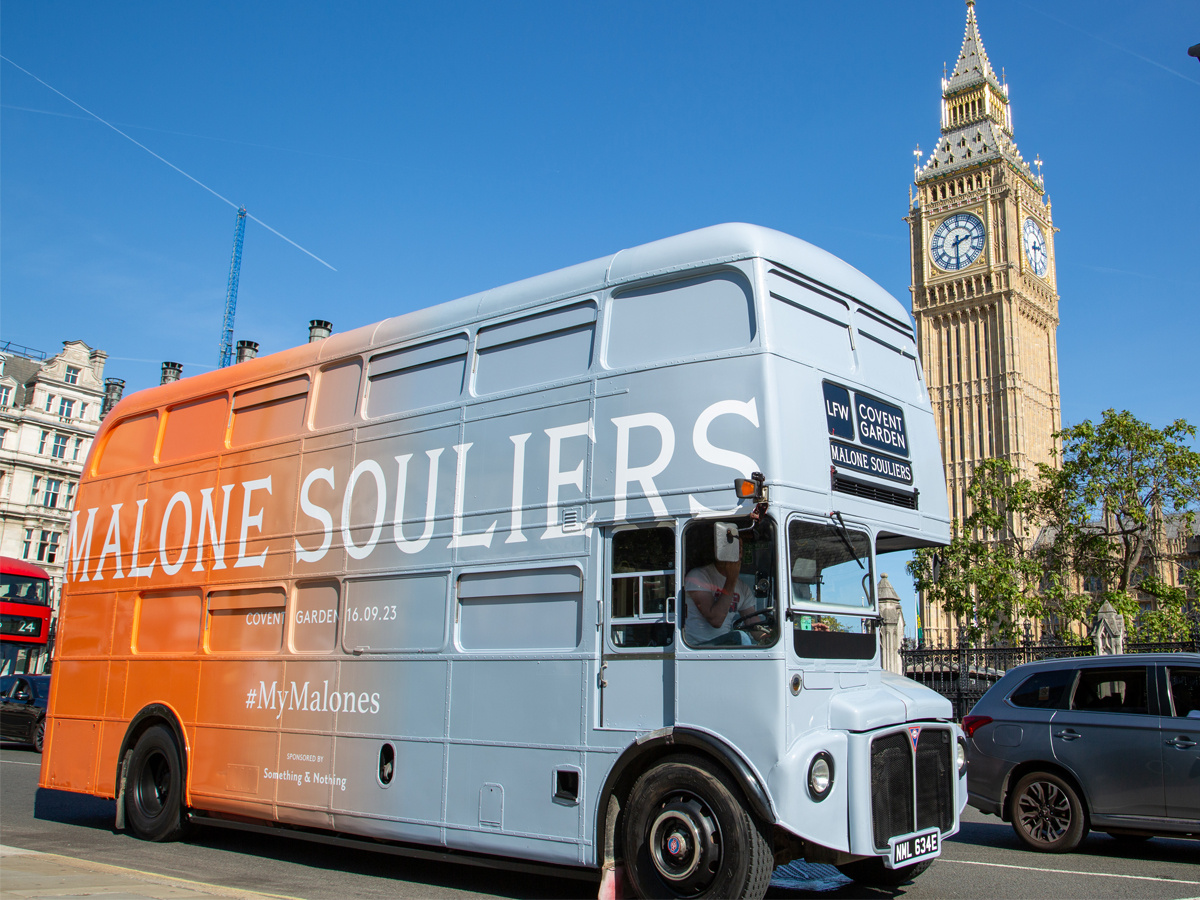 A Routemaster bus hire, seen driving past Big Ben in London.